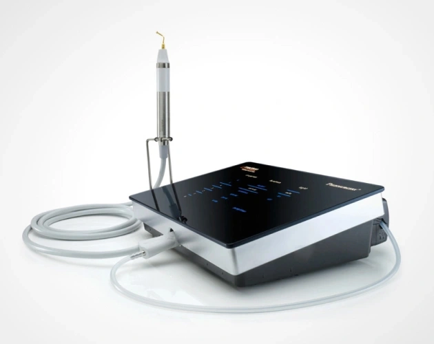 Dental ultrasonic scaler device with handpiece and tubing on white background.
